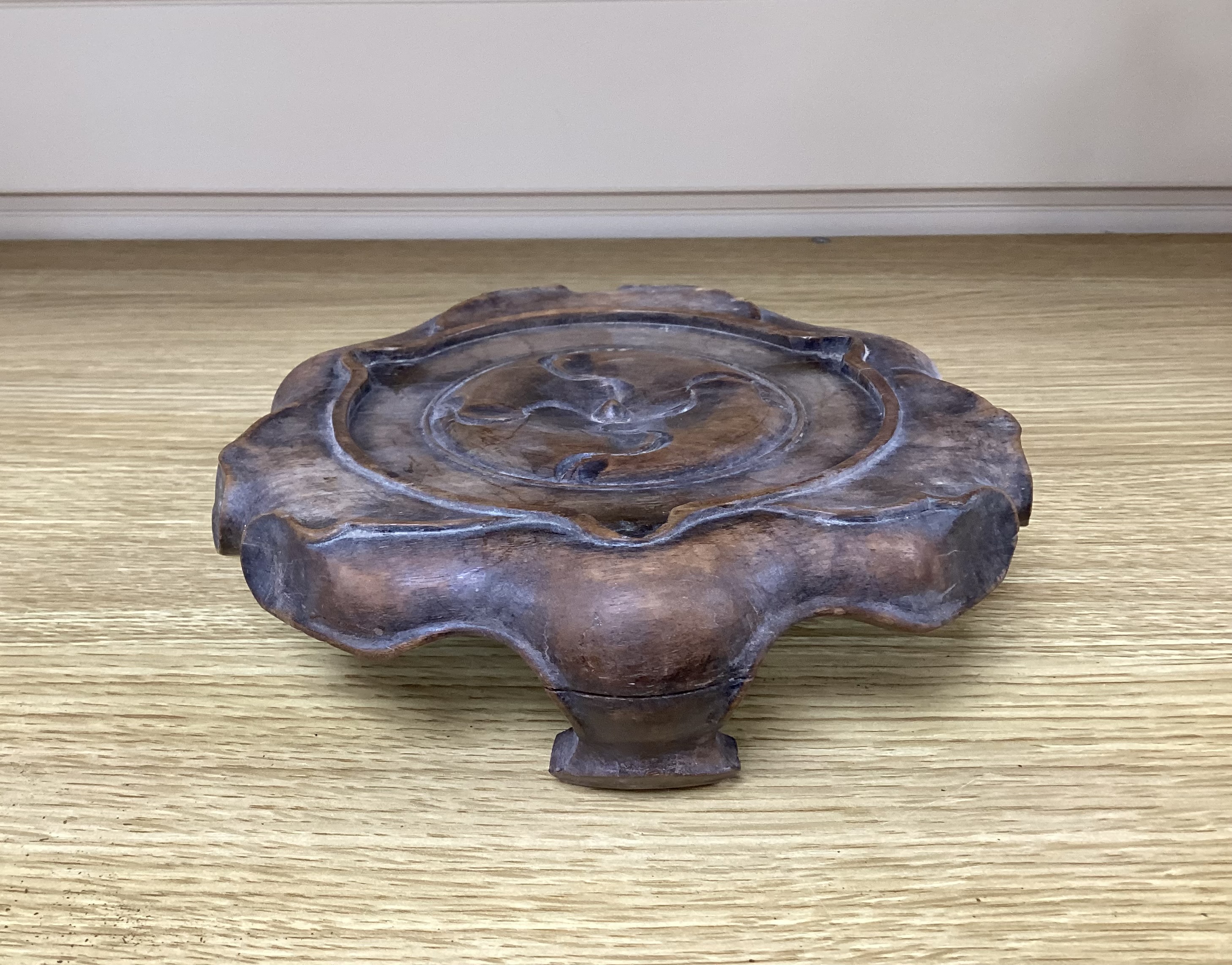 A Chinese bronze tripod censer with twin handles on hardwood stand, censer 19cm wide
